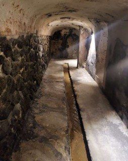 Dark tunnel with channel of water