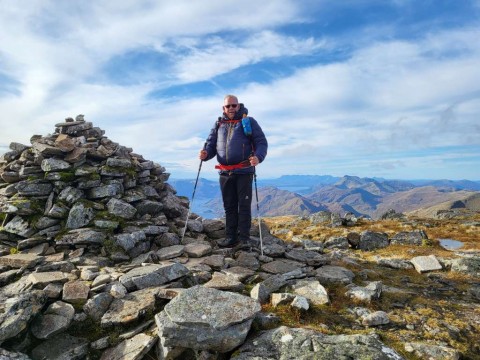 Man standing beside cairn