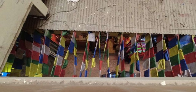Prayer flags above street.